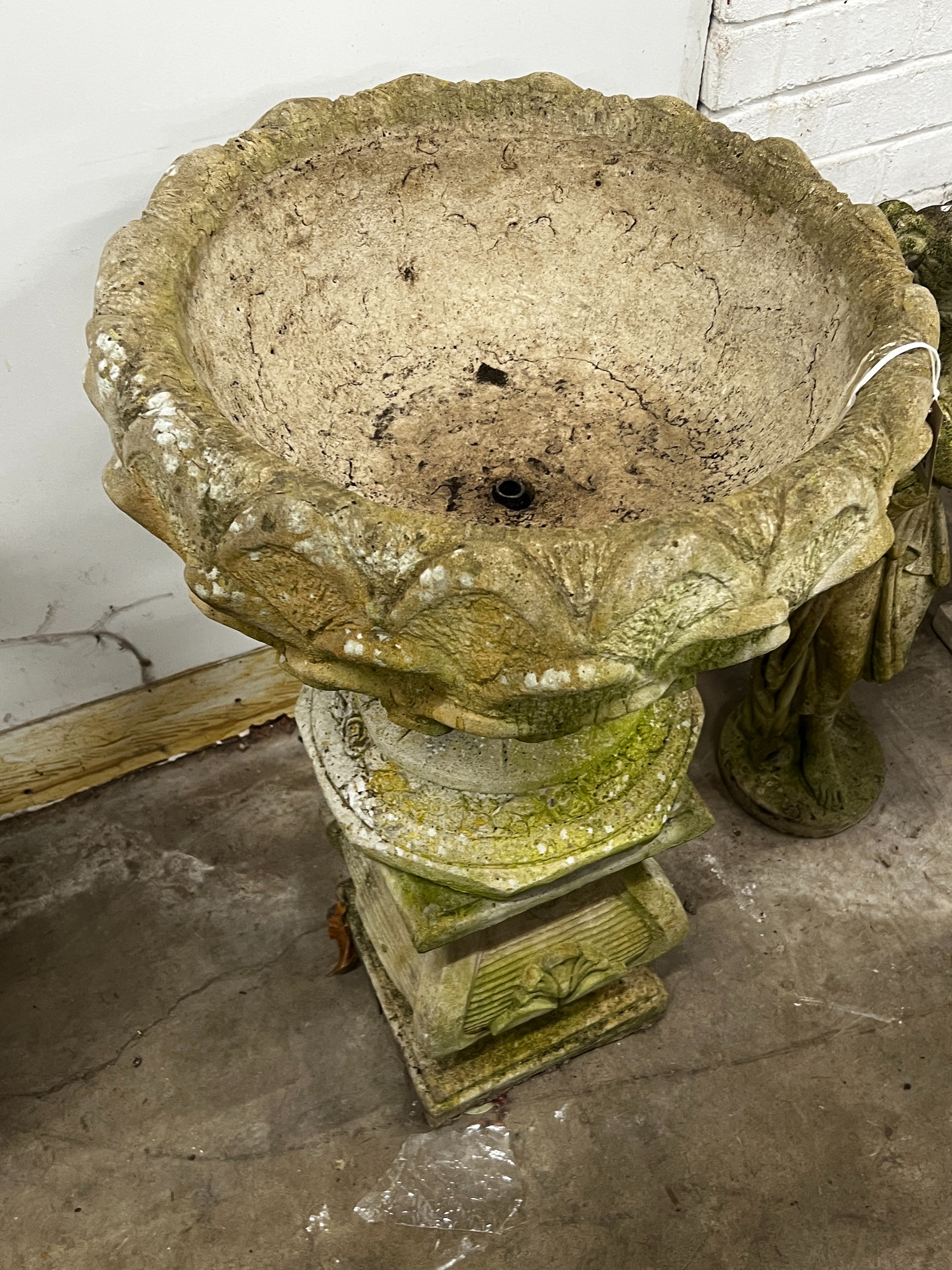 A reconstituted stone circular garden planter on square plinth, diameter 52cm, height 89cm